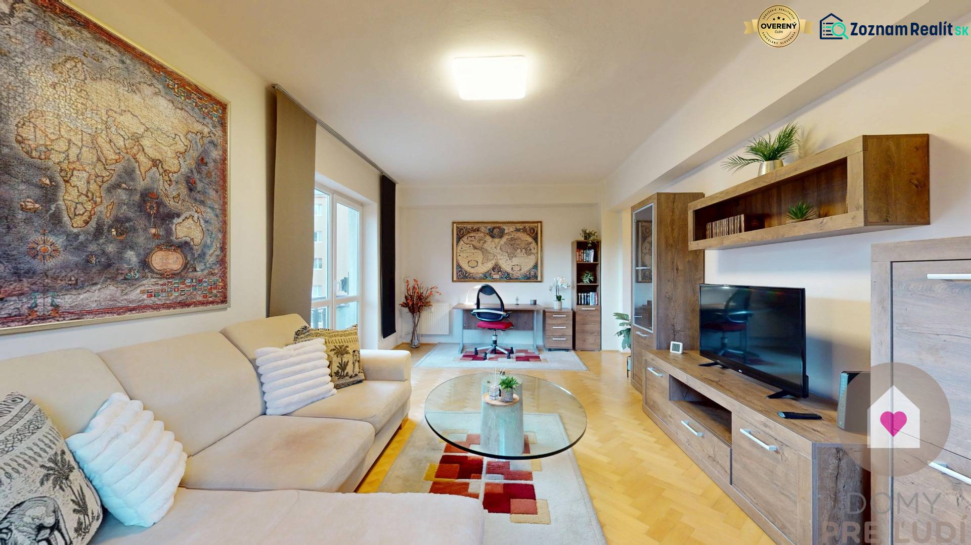 Obývací pokoj v 2-pokojovém bytě s mapou na stěně a podlahou s dřevěným dekorem.