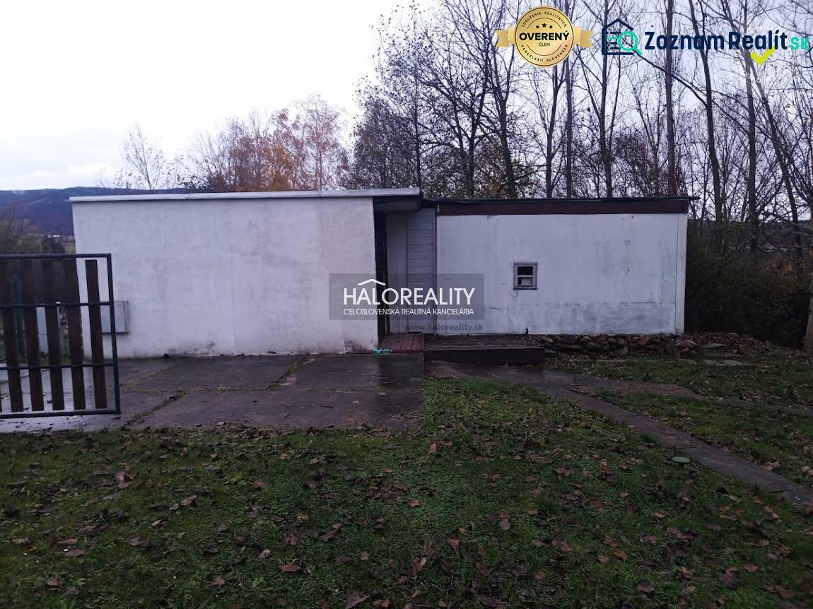 Rekreační pozemky v Nitrianskem Rudnu s jednoduchou stavbou obklopenou přírodou a stromy.