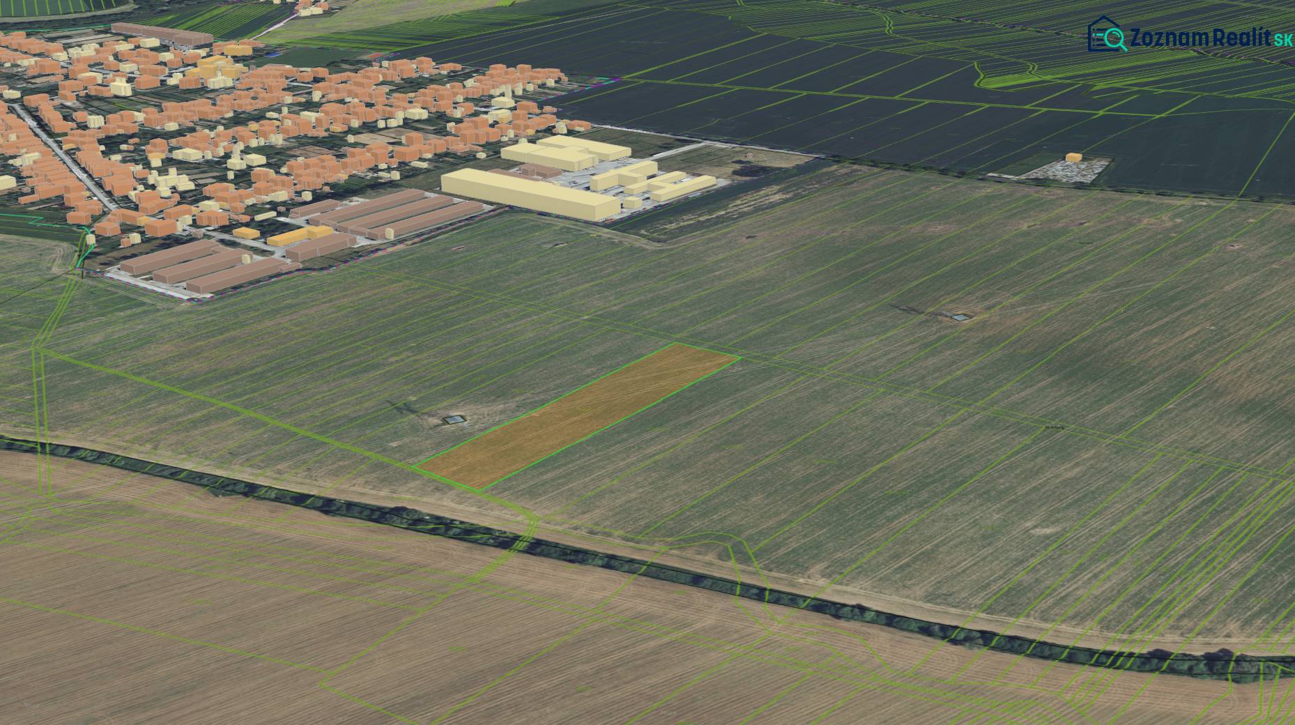 Práznovce z ptačí perspektivy, zemědělské a lesní pozemky obklopující obytnou oblast.
