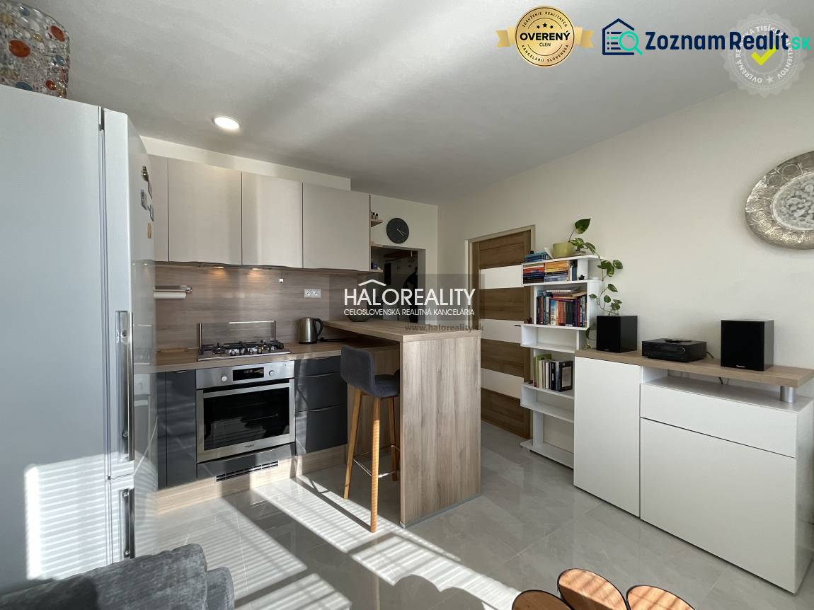 Kuchyně v 1-pokojovém bytě s prosvětleným interiérem a pultem na sezení.