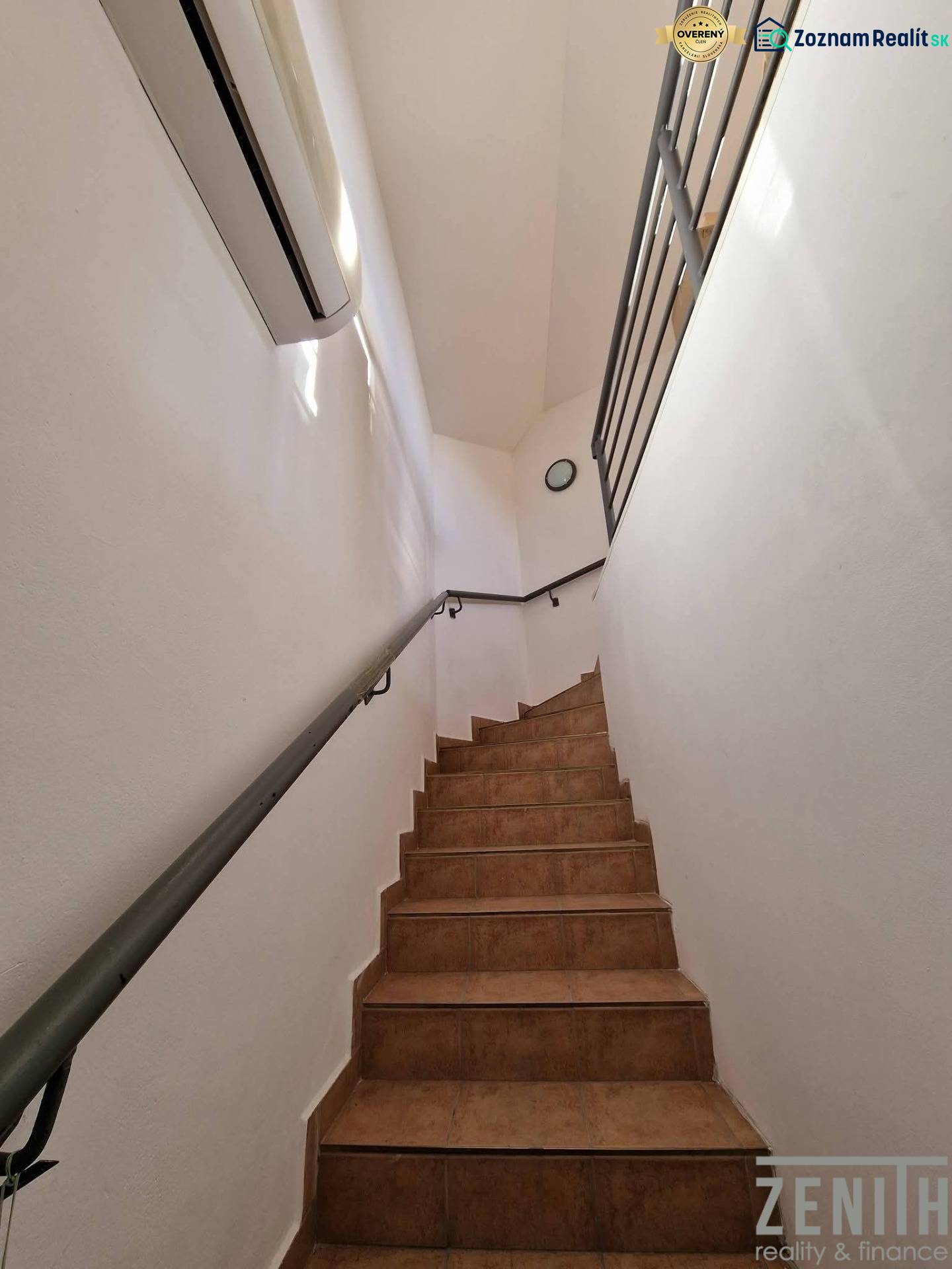 Interiér obchodních prostor s keramickými schody a bílými stěnami.