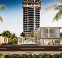 Výstavba bytů v Pattayi ukazuje výškovou budovu obklopenou palmami.