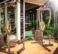 Fitness vybavení ve výstavbě bytů, zelené prvky, osvětlení a zrcadlové stěny.