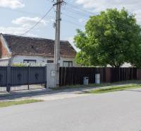 Rodinný dům na ulici Športová v Gajaroch, Pozemky - bydlení s bránou a stromem.