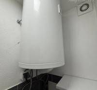 Elektrický bojler v koupelně 1-pokojového bytu zobrazující detaily instalace.