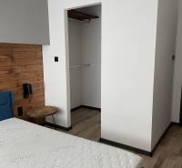 Interiér ložnice s postelí a vestavěnou skříní v 3pokojovém bytě.