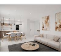 Interiér rekreačního apartmánu zahrnuje kuchyň, jídelní stůl, pohovku a dekorace.