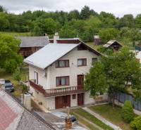 Rodinný dům v obci Daletice obklopený stromy a sousedními budovami.