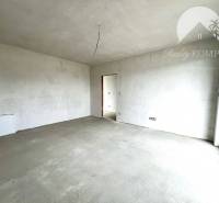 Prázdný interiér v rodinném domě s velkým oknem, bílý strop a stěny.