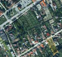 Letecká mapa zobrazuje ulici Školská se zaměřením na pozemky pro bydlení.