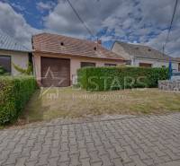 Rodinný dům v Častkovcích s garáží, přilehlou zahradou a vydlážděným chodníkem.