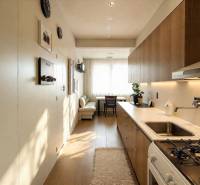 Útulná kuchyně v 3-pokojovém bytě s podlahou s dřevěným dekorem a moderním zařízením.