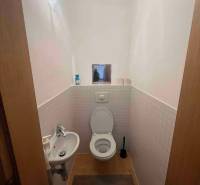 WC ve 3-pokojovém bytě se sanitou, umyvadlem a dlaždicemi.
