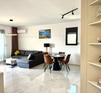 Obývací pokoj s pohodlnou rohovou pohovkou a jídelním stolem v 1-pokojovém bytě.