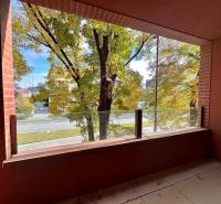 Výhled z balkonu na zeleň a cestu v Bratislavě - Ružinově na Košické ulici.