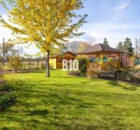 Zahrada rodinného domu v Bílkovej Humence s altánkem a zeleným trávníkem.