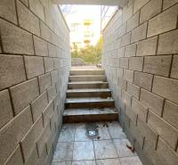 Vchod do sklepa v rodinném domě v Nitře s kamennými stěnami a schody.