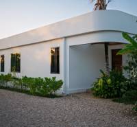 Výstavba domů v Paje, Unguja South Region, se zelení kolem bílého objektu.