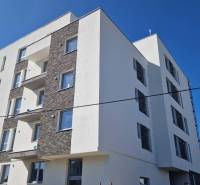 Exteriér bytového domu na Športovní ulici v Galantě, fasáda se světlými stěnami.