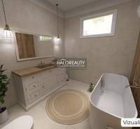 Koupelna v rodinném domě s vanou, umyvadlem, dřevěným dekorem a rostlinou.