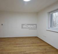 Prázdný pokoj s podlahou s dřevěným dekorem, oknem a světlými stěnami v rodinném domě.