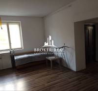 Rodinný dům s podlahou s dřevěným dekorem, oknem a nábytkem.