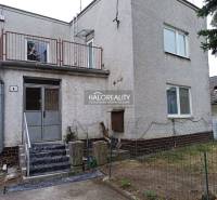 Rodinný dům na Zemplíně se schodištěm, balkonem a řídkým plotem.