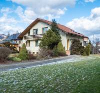 Vila v Žarnovici na ulici Andreja Sládkoviče obklopená zelení a horami.