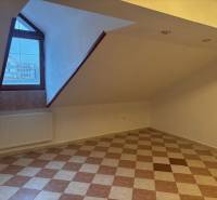 Podkrovní kancelář s dlažbou a oknem, vytápění radiátorem.
