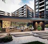 Výstavba bytů v Pattayi, moderní architektura se zelení a venkovními posezeními.
