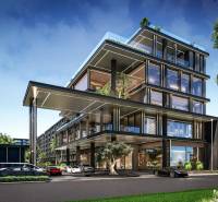 Výstavba bytů v Pattayi se skleněnými fasádami a zelení v okolí.