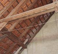 Pohled na střešní konstrukci v rodinném domě s cihlovou krytinou.