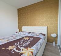 Ložnice s vánočním povlečením, tapetou a květinami ve 3pokojovém bytě.