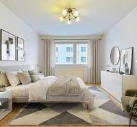 Ložnice v 3-pokojovém bytě s postelí, křeslem a podlahou s dřevěným dekorem.