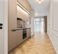 Kuchyně v 2-pokojovém bytě s podlahou s dřevěným dekorem a neutrálními barvami.