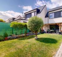 Rodinný dům ve Stupavě s upravenou zahradou, chodníkem a terasou.