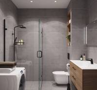 Koupelna se sprchovým koutem, umyvadlem a pračkou v 1-pokojovém bytě.