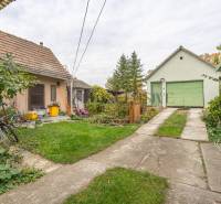 Dvory rodinného domu ve Velkých Dvorníkách se zelení a hospodářskými budovami.