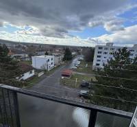 Výhled ze 4pokojového bytu na Gyurkyho v Šahách ukazuje městskou ulici a domy.