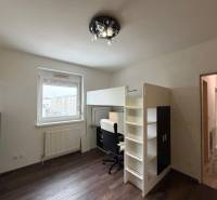 Dětský pokoj ve 3-pokojovém bytě s patrovou postelí a podlahou s dřevěným dekorem.