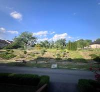 Pokojná zahrada s lavičkou a zelení u 3pokojového bytu v Moravském Lieskovém.