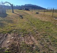 Rozlehlý dvůr s dřevěnými paletami v blízkosti chaty u Kráľovců Krnišova.