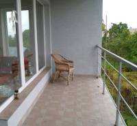 Terasa rodinného domu v Bystričce se zasklenými stěnami a panoramatickým výhledem.