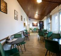 Kavárna s dřevěným stropem a dekorativními židlemi, Gastro prostory.