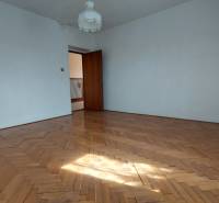 Prostorný pokoj s podlahou s dřevěným dekorem v rodinném domě.