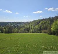 Jarní krajina v okolí Krupiny, Pozemky - bydlení, zelené louky a lesy na horizontu.