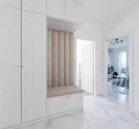 Vstupní hala ve 3-pokojovém bytě s laděným nábytkem a dlažbou s mramorovým vzorem.