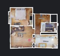 Půdorys 2-pokojového bytu s podlahou s dřevěným dekorem, obývacím pokojem a kuchyní.