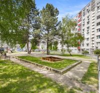 Dvůr plný zeleně s lavičkami a pískovištěm na Kríkové ulici, Bratislava - Vrakuňa.