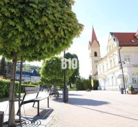 Náměstí v Trenčianských Teplicích s lavičkami, stromy a historickou architekturou, Pozemky - bydlení.